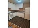 A kitchen with white cabinets, a gas range, and a refrigerator at 6485 Boca Grande Blvd, Forest Park, GA 30297