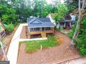 An aerial view of the cozy bungalow showcasing its new driveway and proximity to mature trees at 809 Dill Sw Ave, Atlanta, GA 30310