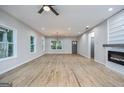 Spacious living room featuring refinished wood floors, recessed lighting, and a modern ceiling fan at 809 Dill Sw Ave, Atlanta, GA 30310