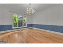 Dining room with large windows, chandelier, and hardwood floors at 821 Carnellian Ln, Peachtree City, GA 30269
