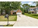 A well-maintained one-story brick home with a two-car garage and a neatly landscaped front yard at 2504 Plymouth Way, Conyers, GA 30013