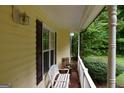 Cozy porch with a bench and view of landscaped yard at 640 Keys Ferry Rd, Mcdonough, GA 30252
