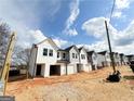 Row of new townhomes with garages in developing area at 11594 E Lovejoy Rd # 1, Hampton, GA 30228