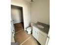 Bathroom with granite countertops and an open doorway to storage room at 11598 E Lovejoy Rd # 3, Hampton, GA 30228