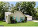 Lovely home with a green lawn and a well-maintained exterior at 1421 Oak Knoll Ne Dr, Conyers, GA 30012
