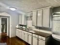 Well-lit kitchen with painted cabinets and stainless steel sink at 1829 Joy Lake Rd, Morrow, GA 30260