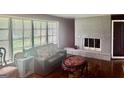 Comfortable living room with a cozy fireplace and large windows at 1829 Joy Lake Rd, Morrow, GA 30260