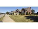 Suburban home boasting well-manicured lawns, mature trees, and neighboring houses along a peaceful street at 3368 Alhambra Cir, Hampton, GA 30228
