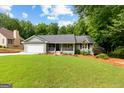 Inviting single-Gathering home with well-kept lawn, charming front porch, and a two-car garage at 431 Hampton Grn, Peachtree City, GA 30269