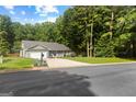 Well-maintained single-Gathering home with a lush lawn, front porch, and mature trees at 431 Hampton Grn, Peachtree City, GA 30269