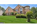 Attractive brick home with manicured lawn and mature landscaping at 3835 Hickory Branch Trl, Suwanee, GA 30024