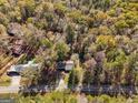 A lush, expansive community surrounding a charming home with a long driveway and proximity to main road at 465 Haynie Rd, Moreland, GA 30259