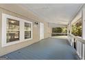 Cozy covered porch with a painted wood floor and white railings that provide a peaceful outdoor space at 465 Haynie Rd, Moreland, GA 30259