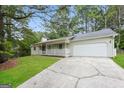 Well-maintained home featuring a two-car garage and a charming covered front porch at 2090 Blackberry Ln, Auburn, GA 30011