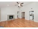 Inviting living room featuring a stone fireplace, hardwood floors, and high vaulted ceilings at 2090 Blackberry Ln, Auburn, GA 30011