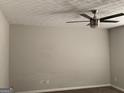 Spacious bedroom with neutral walls and carpet, highlighted by a modern ceiling fan at 135 Green Commons Dr, Covington, GA 30016