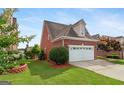 Charming two-story brick home with a well-manicured lawn and two-car garage at 1979 Spivey Village Dr, Jonesboro, GA 30236