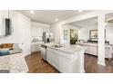Modern kitchen featuring stainless steel appliances, granite countertops, and an open floorplan to living room at 11893 Aukerman Way, Hampton, GA 30228