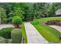 Long, winding driveway leading to a private estate surrounded by lush greenery at 770 Spalding Heights Dr, Atlanta, GA 30350