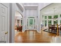 Grand foyer with soaring ceilings, hardwood floors, and elegant architectural details at 770 Spalding Heights Dr, Atlanta, GA 30350