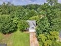 Aerial view of home surrounded by mature trees, spacious yard, and a private setting at 404 Northwind Pl, Stockbridge, GA 30281