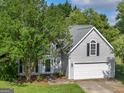 Charming two-story home with well-maintained lawn, mature trees and inviting front entrance at 404 Northwind Pl, Stockbridge, GA 30281