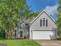Charming two-story home with well-maintained lawn, mature trees and inviting front entrance at 404 Northwind Pl, Stockbridge, GA 30281