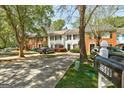 Street view showcasing a row of townhouses, mature trees, and well-maintained landscaping at 5599 Fair Creek Way, Lithonia, GA 30038
