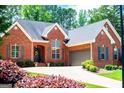 Beautiful brick home boasting a two-car garage, well-maintained landscaping, and an inviting entrance at 109 National Way, Carrollton, GA 30116