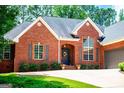 Elegant brick home featuring a well-maintained front yard and arched entryway, showcasing timeless design at 109 National Way, Carrollton, GA 30116