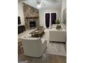 Cozy living room features a stone fireplace, plush seating, and natural light at 207 Oak N Cir, Stockbridge, GA 30281