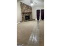 Inviting living room featuring a striking stone fireplace and plush carpeting at 207 Oak N Cir, Stockbridge, GA 30281