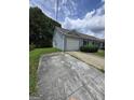 Side view of a charming single-story home with attached garage and driveway at 2985 Garnet Way, South Fulton, GA 30349