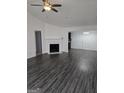 Inviting living room with fireplace, ceiling fan, and seamless flow to dining area at 2985 Garnet Way, South Fulton, GA 30349