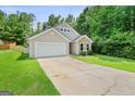 Inviting home showcasing a well-kept yard and a spacious driveway at 107 Meadowbrook Ln, Grantville, GA 30220
