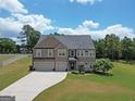 Spacious two-story brick home with manicured lawn, mature landscaping, and a two-car garage at 293 Ironwood Dr, Stockbridge, GA 30281