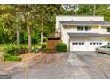 Two-story townhome with a two-car garage in a wooded community at 44 Twiggs Cor, Peachtree City, GA 30269