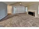 Open-concept living room with fireplace and carpet, filled with natural light at 6630 Pole Creek Dr, Lithonia, GA 30058