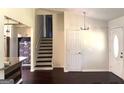 Bright entryway featuring hardwood floors, a staircase, and a view into another room at 7813 Sugarland Dr, Jonesboro, GA 30236