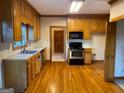 Traditional kitchen featuring wooden cabinets, stainless steel appliances, and hardwood flooring at 823 Mountain View Run, Stone Mountain, GA 30087