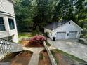 View of a detached two-car garage and landscaped backyard at 3970 Governors Cir, Loganville, GA 30052
