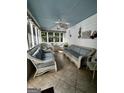 Cozy sunroom with wicker furniture, tile floor, and a ceiling fan at 3970 Governors Cir, Loganville, GA 30052