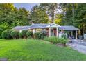 Cozy single-story home with a brick exterior, a well-manicured lawn, and a convenient carport at 8815 Campbellton St, Douglasville, GA 30134