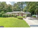 Charming brick home with a covered carport and lush landscaping at 8815 Campbellton St, Douglasville, GA 30134