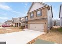 Charming two-story home with brick and siding, two-car garage, and long driveway at 2277 Church St, Hampton, GA 30228