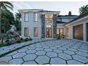 Luxurious home showcasing stone accents, an elegant entryway, designer lighting, and a beautiful paver driveway at 3181 Buck Branch Rd, Conyers, GA 30094