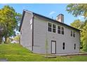 The backyard showing the gray horizontal siding and multiple windows at 5368 Nw Stafford Nw Dr, Lilburn, GA 30047