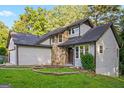 Charming home showcasing stone accents, gray siding, and a neatly maintained front lawn at 5368 Nw Stafford Nw Dr, Lilburn, GA 30047