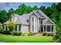 Charming two-story home featuring mature landscaping, a manicured lawn, and a welcoming front porch at 204 Pinehurst Way, Carrollton, GA 30116