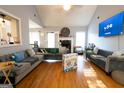 Spacious living room featuring modern gray sofas, hardwood floors, and a fireplace at 1858 Mcconnell Rd, Grayson, GA 30017